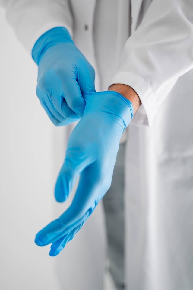 high-angle-doctor-putting-gloves high-angle-doctor-putting-gloves